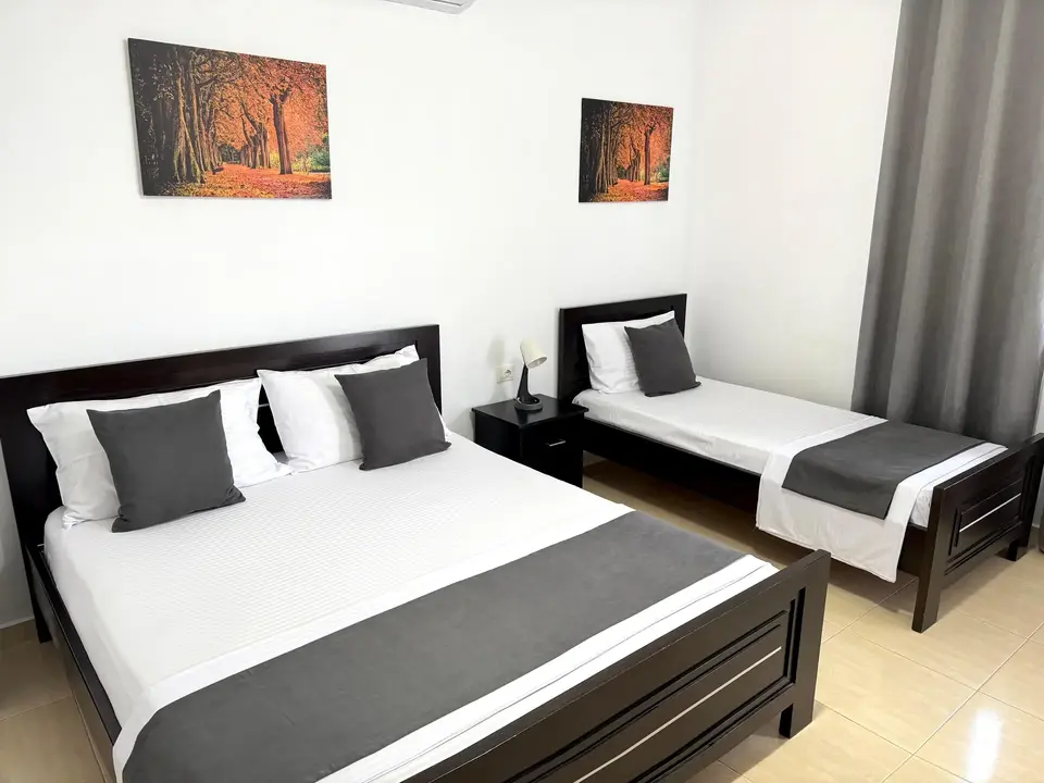 Double Room with Garden View showing the double and single beds