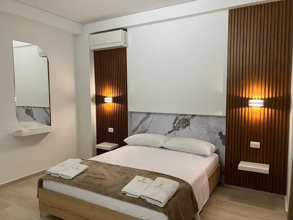 Double Room with Mountain View showing the bed and modern wood feature wall