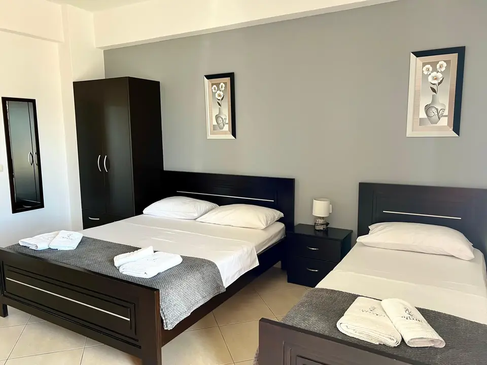 Triple Room with Sea View showing the double bed and single bed