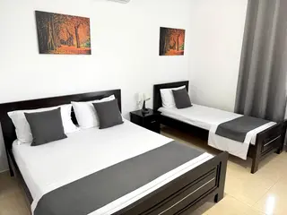 Double Room with Garden View showing the double and single beds — thumbnail