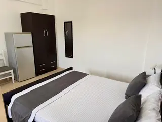 Wardrobe and refrigerator in the Double Room with Garden View — thumbnail