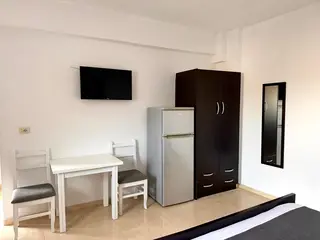 Dining table, television and storage in the Double Room with Garden View — thumbnail