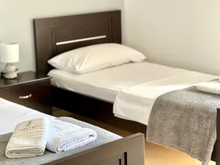 Prepared single beds and towels in the Triple Room with Sea View — thumbnail