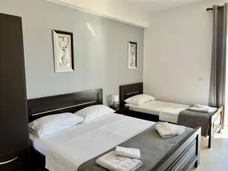 Wide interior view of the Triple Room with Sea View — thumbnail