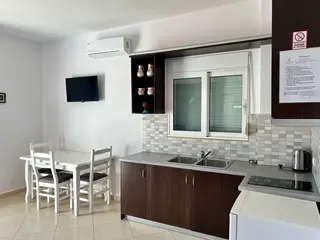 Full kitchenette and dining space in the Triple Room with Sea View — thumbnail